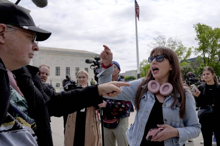 Demonstrators protest outside the Supreme Court as the justices prepare to hear arguments over whether Donald Trump is immune from prosecution in a case charging him with plotting to overturn the results of the 2020 presidential election, on Capitol Hill Thursday, April 25, 2024, in Washington. (AP Photo/Mariam Zuhaib)