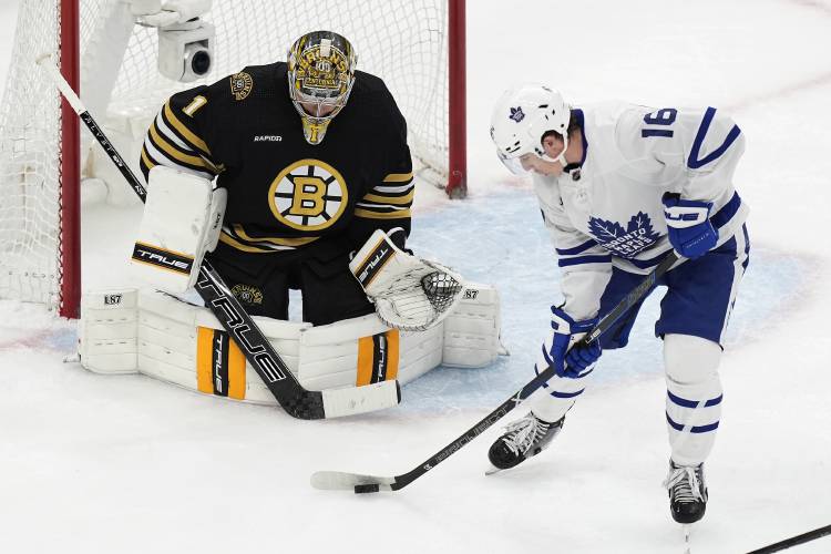 Toronto Maple Leafs' Mitch Marner (16) tries to get a shot on Boston Bruins' Jeremy Swayman (1) during the first period in Game 1 of an NHL hockey Stanley Cup first-round playoff series Saturday, April 20, 2024, in Boston. (AP Photo/Michael Dwyer)