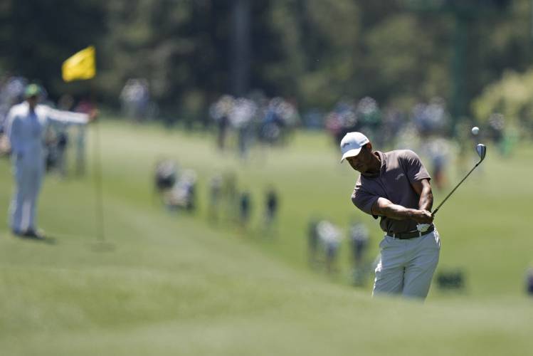 Tiger Woods hits from the fairway on the eighth hole during second round at the Masters golf tournament at Augusta National Golf Club Friday, April 12, 2024, in Augusta, Ga. (AP Photo/Charlie Riedel)