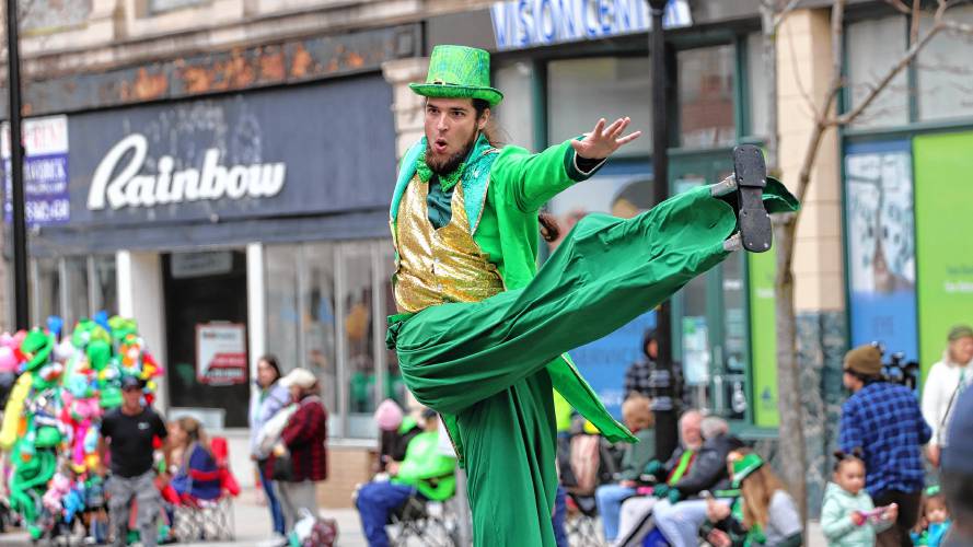  A stiltwaker performs as part of the 71st annual St. Patrick’s Day parade in Holyoke on Sunday.