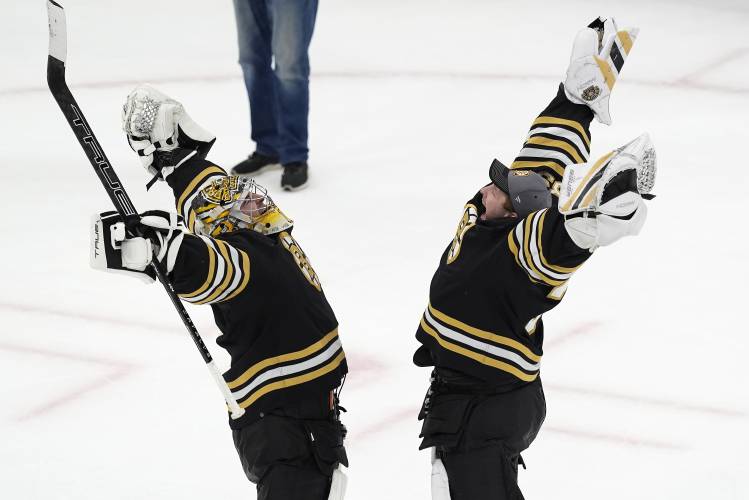 Boston Bruins' Jeremy Swayman, left, and Linus Ullmark celebrate the team's win over the Toronto Maple Leafs in Game 1 of an NHL hockey Stanley Cup first-round playoff series Saturday, April 20, 2024, in Boston. (AP Photo/Michael Dwyer)