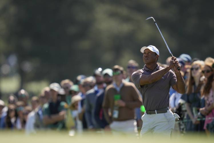 Tiger Woods watches his chip on the 18th hole during second round at the Masters golf tournament at Augusta National Golf Club Friday, April 12, 2024, in Augusta, Ga. (AP Photo/Ashley Landis)