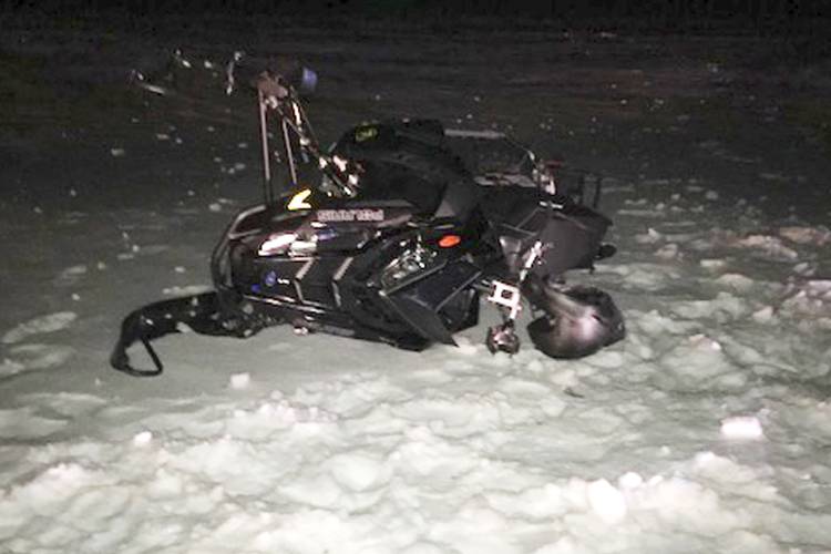 A damaged snowmobile which crashed with a Black Hawk helicopter, March 13, 2019, in Worthington. A Massachusetts man wants the government to pay nearly $10 million after being badly injured in a crash with a Black Hawk helicopter. The lawsuit filed by Jeffrey Smith against the government follows a 2019 crash in which Smith’s snowmobile collided with the helicopter that was parked on a trail at dusk. 