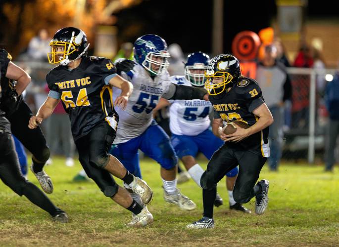 Smith Vocational’s Brayden LaRose (33) runs for a gain in the second quarter against Blue Hills on Friday night in Northampton.