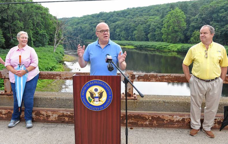 Congressman Jim McGovern is flanked by Deerfield Select Board members Carolyn Shores Ness and Tim Hilchey on the Stillwater Bridge over the Deerfield River in Deerfield to announce legislation that would add the river to the National Wild and Scenic Rivers System.