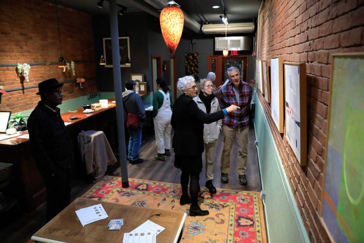 People gather at the Northampton arts and community space Rhynia during Arts Night Out. Easthampton artist Amanda Barrow’s show, “The Asian Wall Series,” is being shown this month.