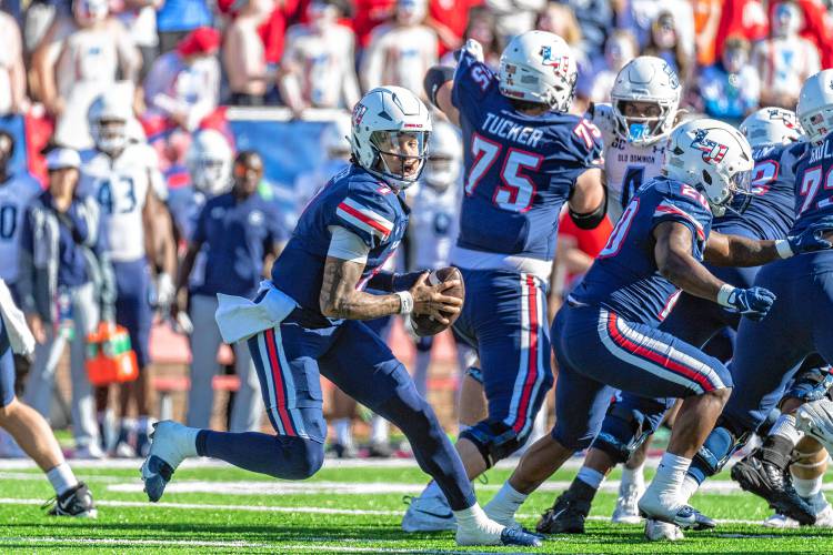 Liberty's Kaidon Salter looks to run with blockers Jack Tucker and Quinton Cooley in front during the first half against Old Dominion last weekend in Lynchburg, Va.