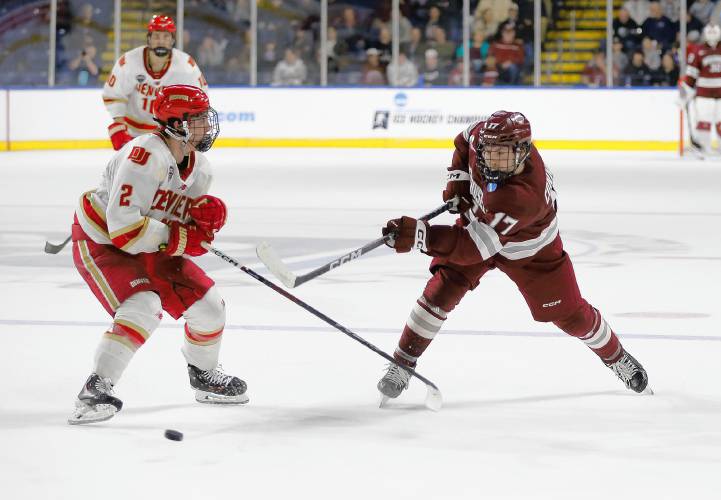 UMass forward Kenny Connors (17) fires a shot past Denver’s Sean Behrens (2) in the second period of the opening round of the NCAA tournament Friday at the MassMutual Center in Springfield.
