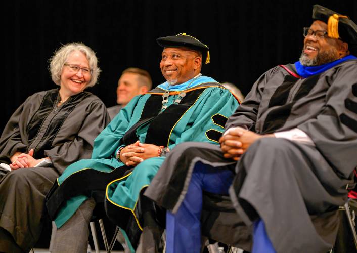 New Holyoke Community College President George Timmons, center, shares a laugh at his inauguration Friday with Vanessa Smith, interim chair of the board of trustees, and Patrick Tutwiler, Massachusetts secretary of education.
