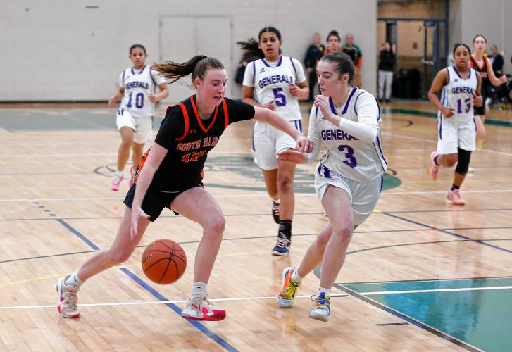 South Hadley’s Cara Dean (12) drives to the hoop against Pittsfield defender Charlotte Goodnow (3) in the third quarter of the Western Mass. Class B girls basketball championship Saturday at Holyoke Community College.