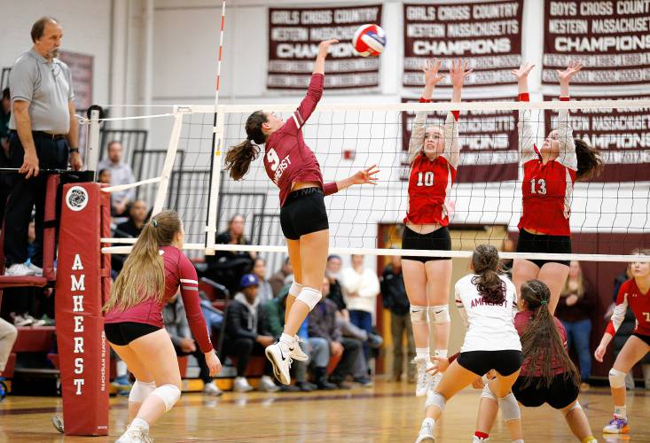 Amherst’s Ruby Austin (9) attacks at the net in the fourth set against Holliston during the MIAA Division 3 quarterfinal Thursday in Amherst.