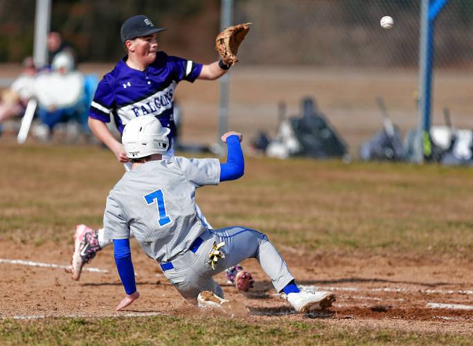 Granby baserunner Nikolas Misiaszek (7) slides safely into home plate to score ahead of the tag from Smith Academy pitcher Harry LaFlamme (23) in the bottom of the first inning Friday in Granby.