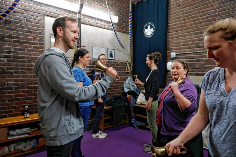 Myles Dakan, from left, Gwen Gethner, Dan Lynds, Charlotte Taylor-Snipes, Kate McIntosh and Rachel Griffin-Snipes participate in a change ringing handbell practice, a style of bell ringing that uses mathematical patterns rather than melodies, inside Smith College’s Mendenhall Bell Tower as part of the first Smith Arts Day on Saturday in Northampton. Presented by the Smith Office for the Arts, the daylong celebration of the artistic and creative community at Smith College included a variety of performances, exhibitions, workshops, and art-making activities across campus.