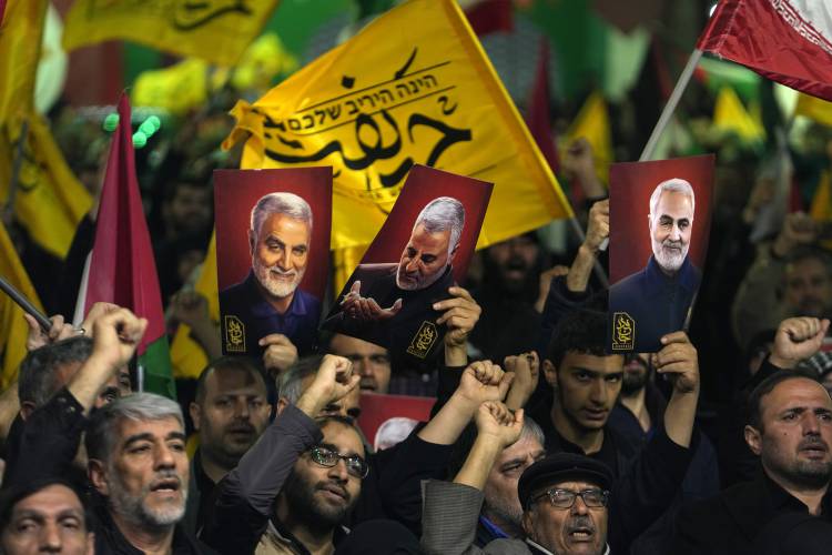 Iranian protesters chant slogans on April 1 as they hold up posters of the late Iranian Revolutionary Guard Gen. Qassem Soleimani, who was killed in a U.S. drone attack in 2020, as they protest the Israeli bombing of the Iranian embassy in Syria.