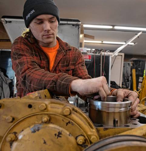 Devon McDonald, an employee of Harrison Diesel Solutions, rebuilds an engine cylinder liner at the business at 4 Linseed Road in Hatfield.  