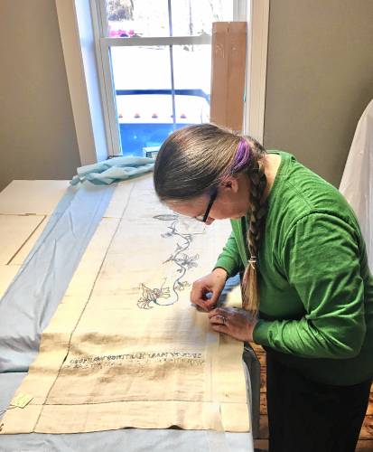 Hatfield Historical Museum curator Meguey Baker prepares an 18th century Rebecca Dickinson-designed piano scarf for display at a Washington, D.C. museum.