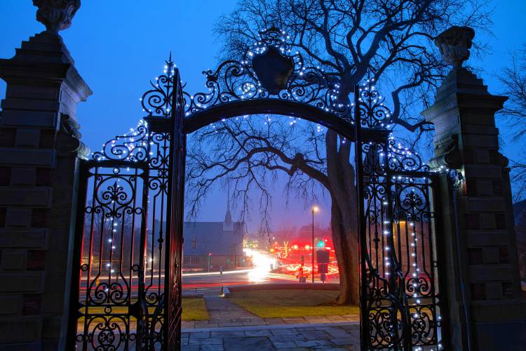 Traffic streams through downtown Northampton looking through the gates of the Smith College campus.