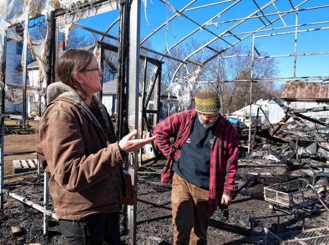 Sarah and Ryan Voiland, owners of Red Fire Farm in Granby,  talk Tuesday about the damage from the fire Saturday afternoon and what it will take to rebuild.