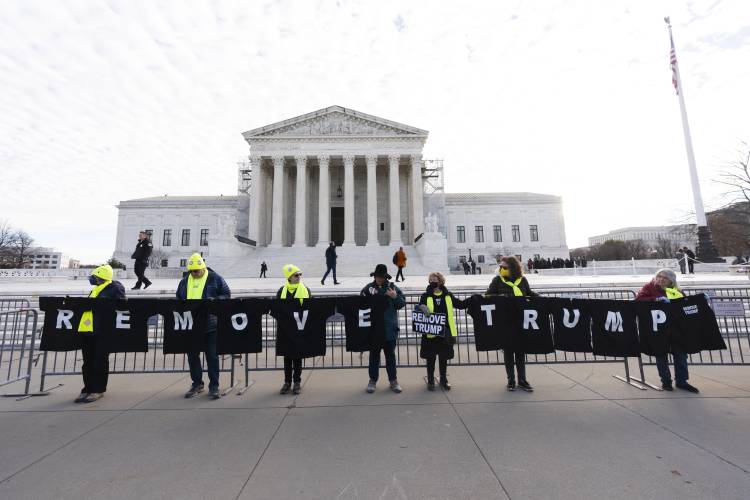 Protesters hold their banners in front of the U.S. Supreme Court, Thursday, Feb. 8, 2024, in Washington. (AP Photo/Manuel Balce Ceneta)