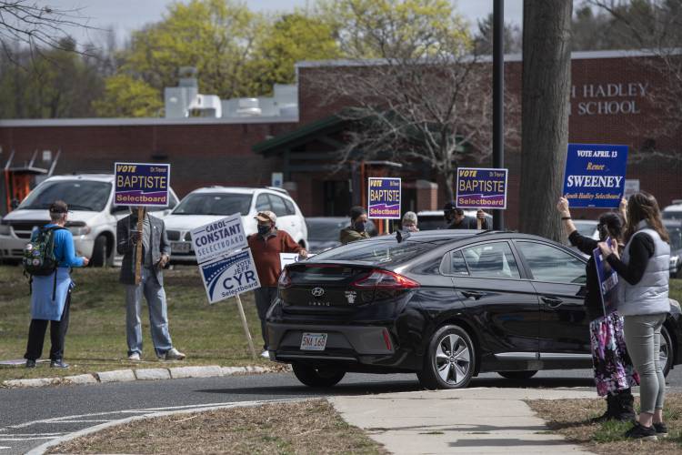 Supporters of candidates in South Hadley’s 2021 town election wave to residents arriving at the high school to vote. In advance of this year’s election, Know Your Town of South Hadley will sponsor and moderate a Candidates Night on Thursday at the South Hadley Library.