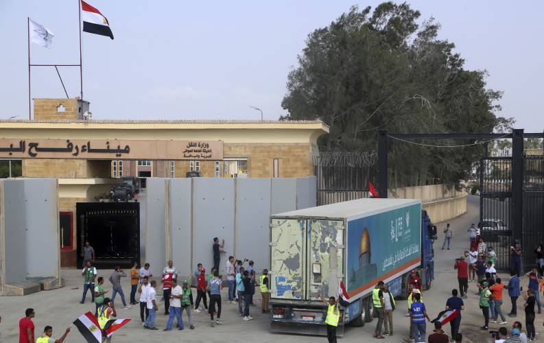 A truck carrying humanitarian aid for the Gaza Strip crosses the Rafah border gate in Rafah, Egypt, Sunday, Oct. 22.