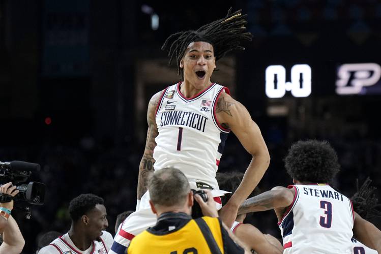 UConn guard Solomon Ball (1) celebrates as time expires during the second half of the NCAA college Final Four championship basketball game against Purdue, Monday, April 8, 2024, in Glendale, Ariz. (AP Photo/Brynn Anderson)