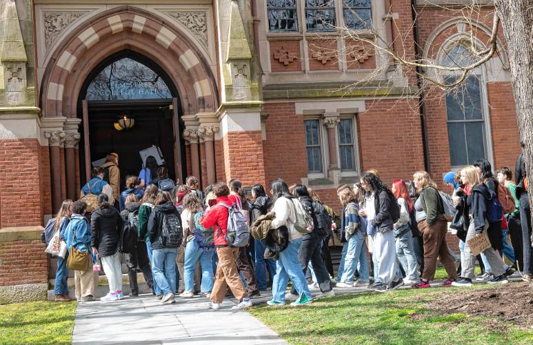 Smith College students enter College Hall as part of a protest demanding divestment from military contractors on Wednesday. 