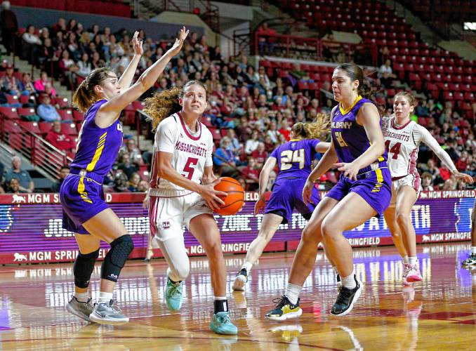 UMass guard Kristin Williams (5) drives to the hoop against UAlbany earlier this season at the Mullins Center in Amherst.