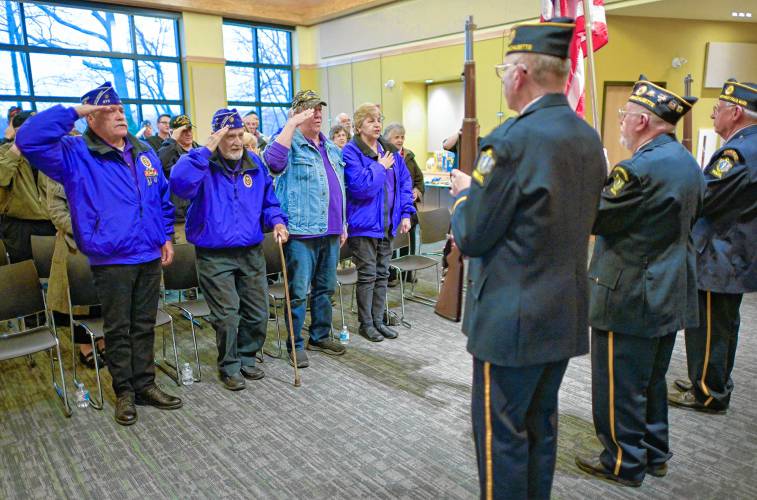 Vietnam veterans salute during South Hadley’s National Vietnam War Veterans Day Commemoration at the South Hadley Public Library on Thursday.