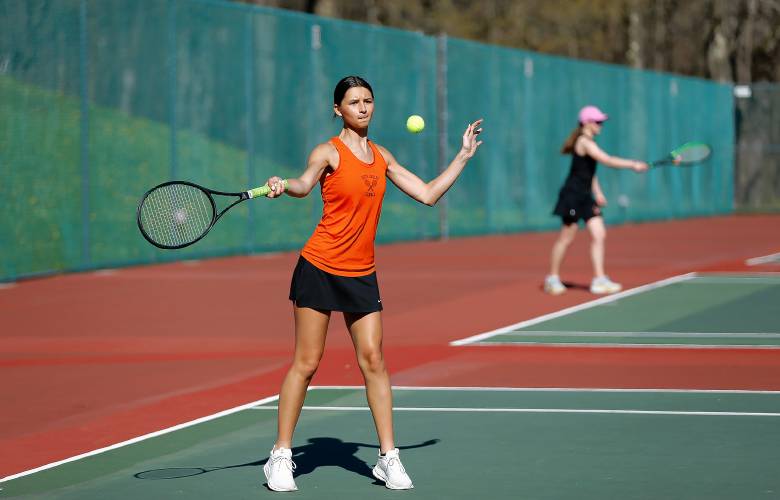 South Hadley’s Yanna Stefoglo volleys against Belchertown’s Amanda Murray during their No. 2 singles match Thursday at Mount Holyoke College.