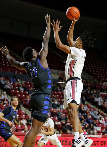 UMass forward Daniel Hankins-Sanford (1), right, puts up a shot in the paint over CCSU forward Abdul Momoh (11) earlier this season at the Mullins Center in Amherst.