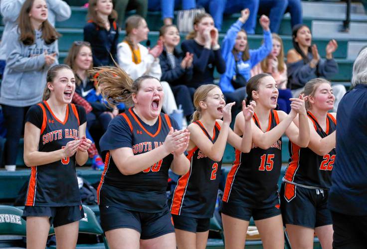 The South Hadley sideline celebrates after scoring against Pittsfield in the fourth quarter of the Western Mass. Class B girls basketball championship earlier this season at Holyoke Community College.