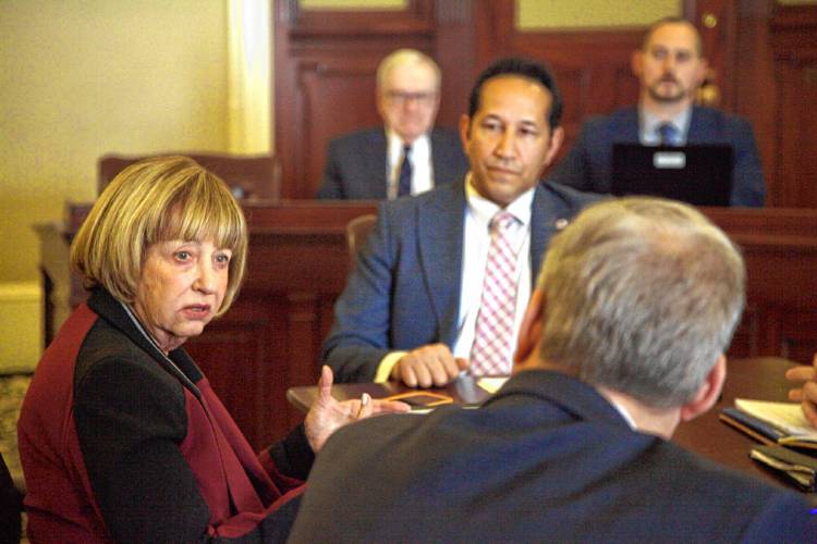 Sen. Cindy Creem talks to Sen. Bruce Tarr about a vote to close meetings between the conference committee tasked with negotiating a major gun control reform bill to the public.  