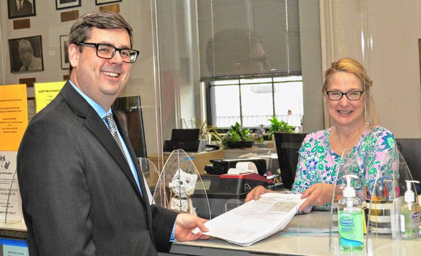 Rep. Dan Carey, D-Easthampton, picks up certified nomination papers for Hampshire County clerk of courts from Northampton City Clerk Pamela L. Powers on Friday.