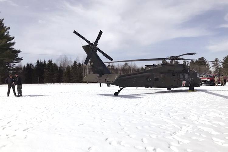 In this U.S. Army photograph by attorney Douglas Desjardins, a damaged Black Hawk helicopter rests on the snow, March 13, 2019, in Worthington. A Massachusetts man wants the government to pay nearly $10 million after being badly injured in a crash with a Black Hawk helicopter. The lawsuit filed by Jeffrey Smith against the government follows a 2019 crash in which Smith’s snowmobile collided with the helicopter that was parked on a trail at dusk.  