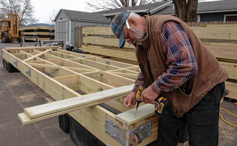 Mark Hopf, an employee of Sportsman’s Marina in Hadley, builds docks last week to replace the many that the marina lost last July to flooding. 