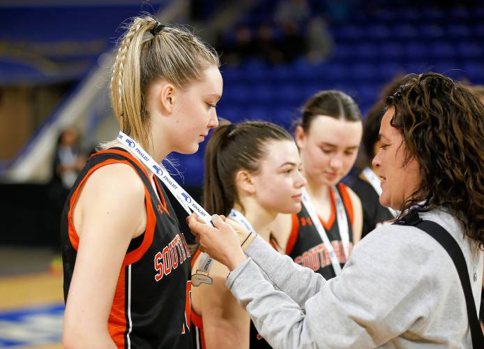 South Hadley’s Ava Asselin receives a finalist medal after the MIAA Div. 4 girls basketball state final against Cathedral on Sunday afternoon at the Tsongas Center in Lowell.