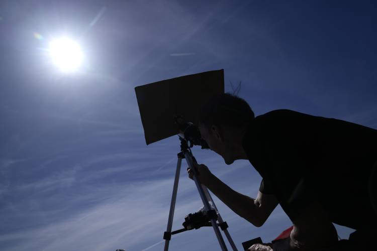 Mike Porter uses a telescope to get a look at the sun as he prepares to watch a total solar eclipse Monday, April 8, 2024, in Carbondale, Ill. (AP Photo/Jeff Roberson)