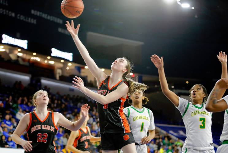 South Hadley’s Caitlin Dean (14) puts in a layup against Cathedral in the fourth quarter of the MIAA Div. 4 girls basketball state final Sunday afternoon at the Tsongas Center in Lowell.