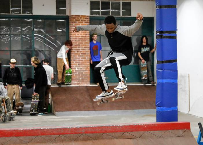 Divante Clark of Springfield goes over a ramp  at the Easthampton Skate Club at Eastworks.