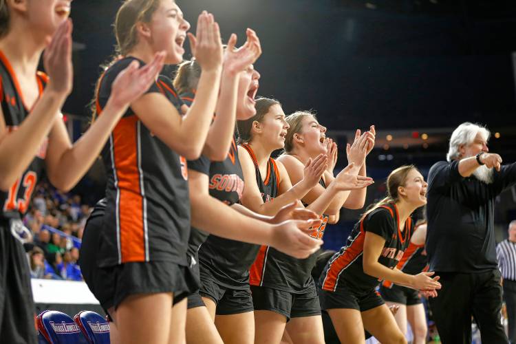 The South Hadley sideline cheers in the fourth quarter against Cathedral during the MIAA Div. 4 girls basketball state final Sunday afternoon at the Tsongas Center in Lowell.