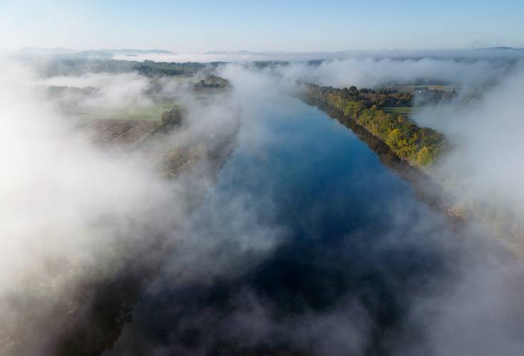 Fog rolls through across the valley over the Connecticut River in the early morning, looking south from Sunderland.