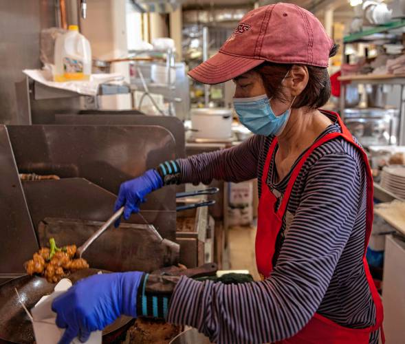 Clara Li, owner of the Little Wall in Florence, makes a takeout order of walnut chicken on a recent afternoon. Li, who for years operated Great Wall on Pine Street in Florence with Ken Cheung, sold that restaurant and recently opened a smaller version of the Chinese restaurant on Main Street.    