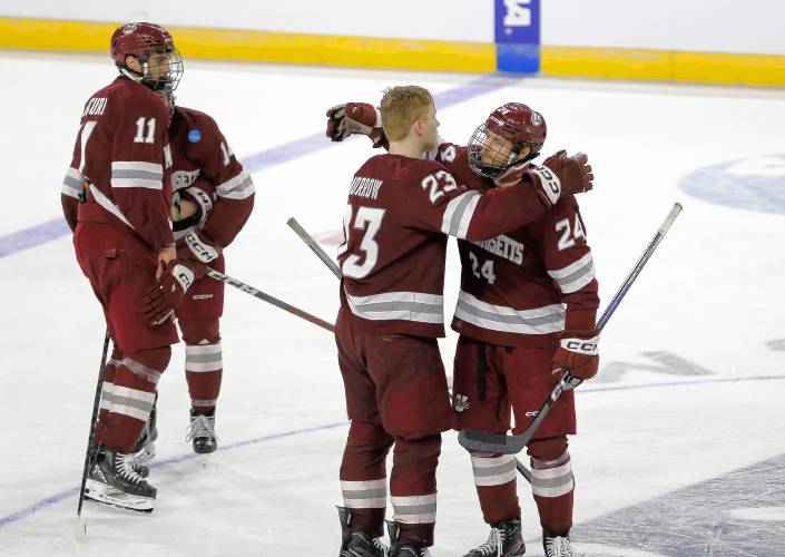UMass players embrace after their 2-1 double-overtime loss against Denver in the opening round of the NCAA tournament Friday at the MassMutual Center in Springfield.