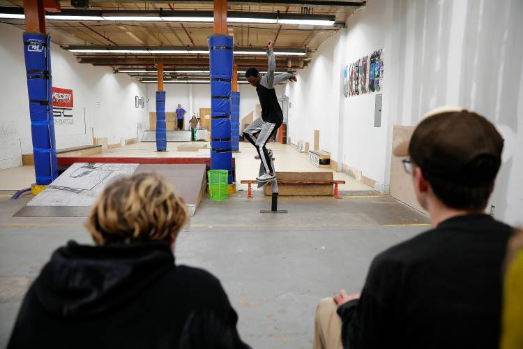 Divante Clark of Springfield rides a rail  at the Easthampton Skate Club at Eastworks.