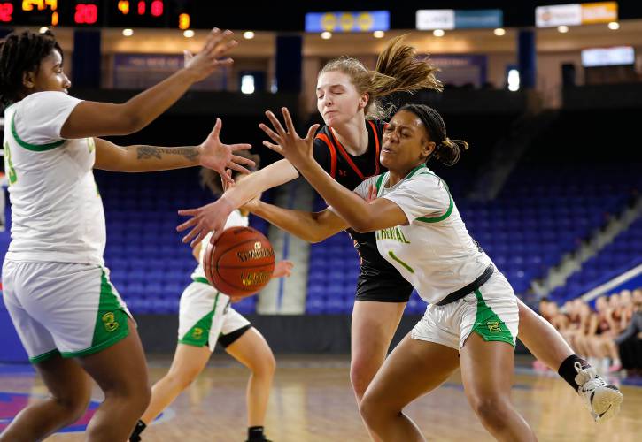 South Hadley’s Kate Phillips (24) fights for a loose ball against Cathedral’s E' Mani Richardson (23), left, and Tamia Darling (1) in the first quarter of the MIAA Div. 4 girls basketball state final Sunday afternoon at the Tsongas Center in Lowell.