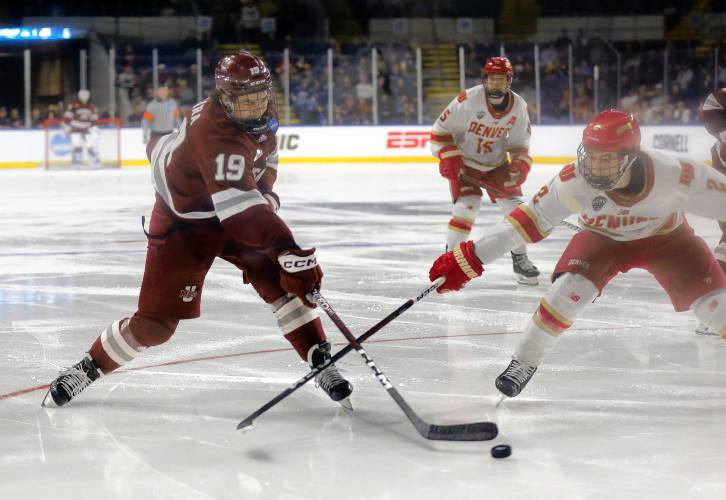 UMass forward Cole O'Hara (19) fires a shot against Denver in the third period of the opening round of the NCAA tournament Friday at the MassMutual Center in Springfield.