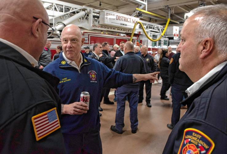 Robert Authier, middle, retiring South Hadley fire chief, talks with Jon Davine, left, Massachusetts fire  marshal, and Paul Morrissette, the East Longmeadow fire chief, during a celebration of Authier's   retirement at the South Hadley station Friday afternoon, Jan 5, 2024.