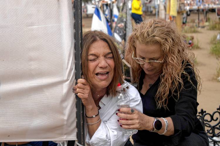 Mothers of young people killed in a cross-border attack by Hamas that killed or kidnapped hundreds of revelers at the Nova music festival react to seeing their children's markers, at the site in Re'im, southern Israel, on the sixth month anniversary of the Oct. 7, 2023 attack, on Sunday, April 7, 2024.