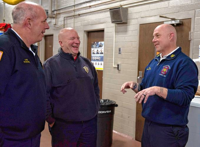 Robert Authier, right, retiring South Hadley fire chief, talks with, Michael Spanknebel, left Hadley Fire Chief and John Wood, during a celebration of Authier's   retirement at the South Hadley station Friday afternoon, Jan 5, 2024.